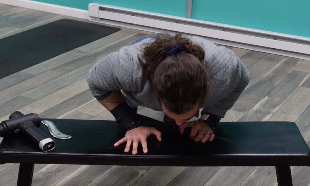 A front view of Dr. John doing a push up with muscle floss on to help break up adhesions and scar tissue